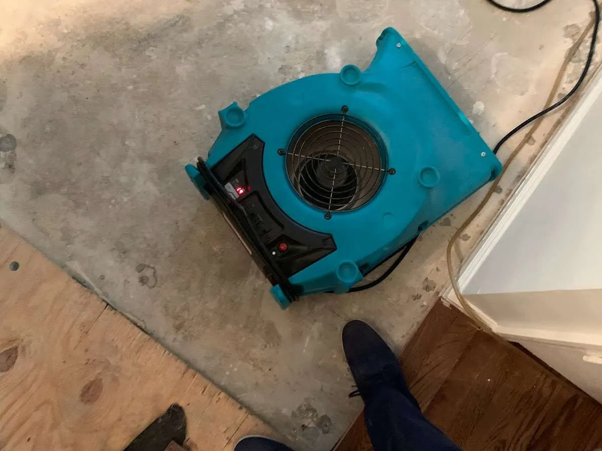 Air mover drying subfloor during Leak Detection & Repair in Muscoy